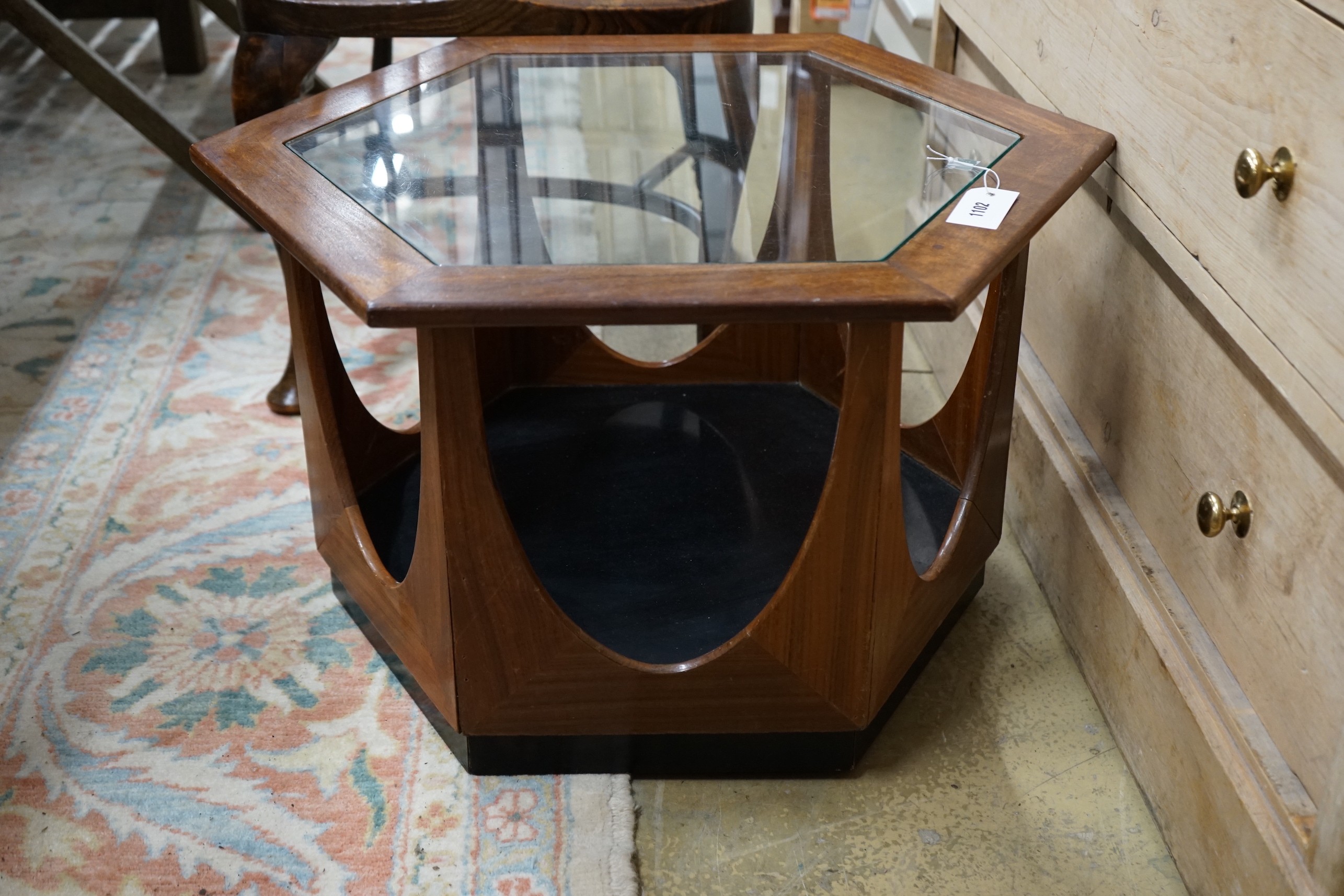 A mid century design hexagonal teak brass top coffee table, width 63cm, height 42cm